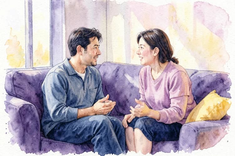 Um casal discutindo de forma calma, com linguagem corporal aberta.